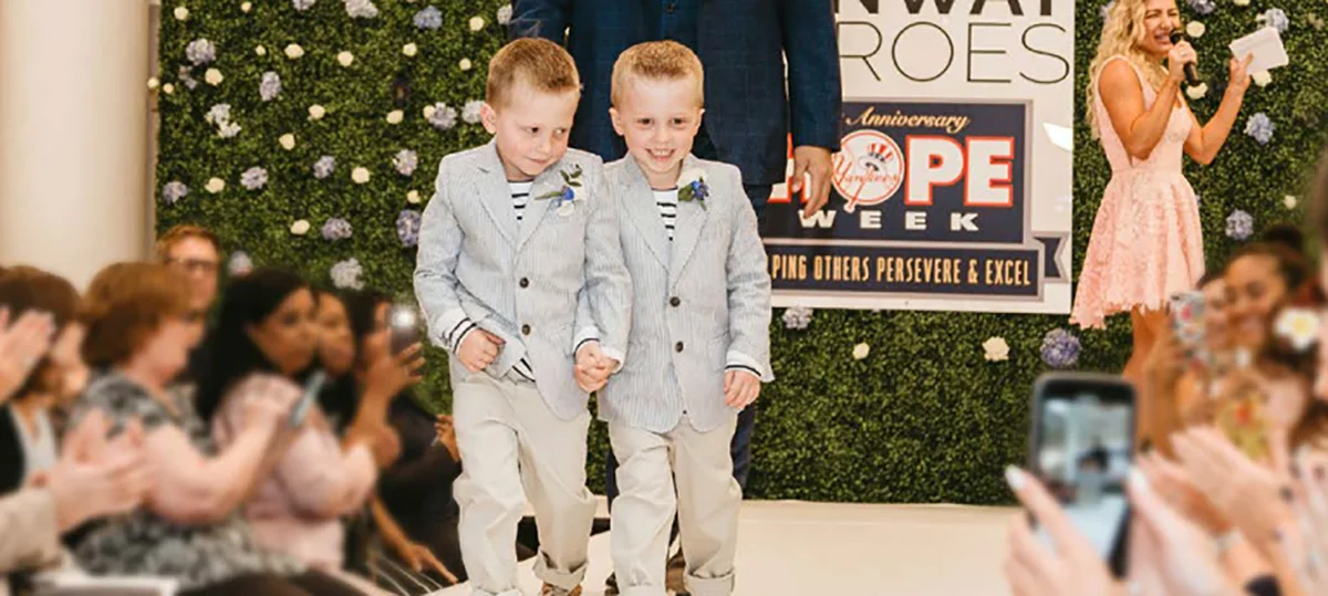 Two little boys in suits on a runway