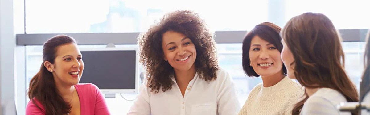 Women sitting at a desk having a meeting
