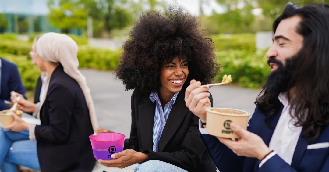 people eating from lunch boxes.