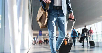 person pulling a piece of luggage.
