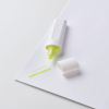 a white and yellow highlighter on a white surface