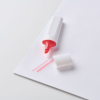 a white and red highlighter on a white surface