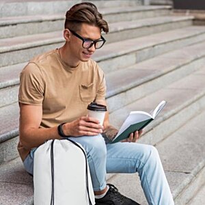 Additional Image 1 - a man sitting on stairs reading a book