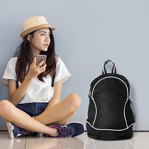 Additional Image 4 - a woman sitting on the floor next to a backpack