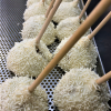 a row of white balls with brown sticks