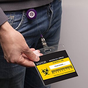 Additional Image 1 - a person holding a yellow and black badge