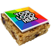 a square brownie with a rainbow colored square with a white text on it