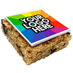 Additional Image 2 - a square brownie with a rainbow colored square with a white text on it