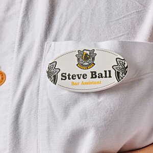 Additional Image 1 - a person wearing a white shirt with a white oval shaped badge