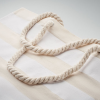 a white rope on a white striped surface