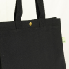 a black bag with a gold button