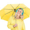 a woman holding a yellow umbrella