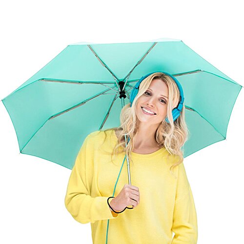 Additional Image 6 - a woman wearing headphones and holding an umbrella