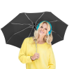 a woman wearing headphones and holding an umbrella