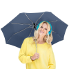 a woman wearing headphones and holding an umbrella