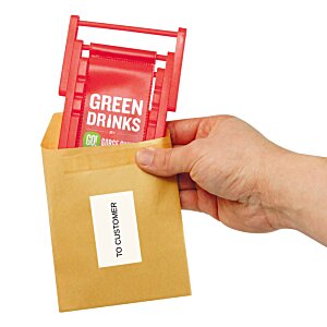Additional Image 3 - a hand holding a brown envelope with a red packet