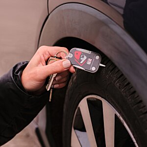 Additional Image 4 - a person holding a key to a tire