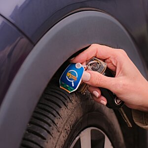 Additional Image 5 - a person's hand holding a blue canister to a tire