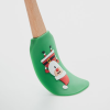 a green sock with a santa claus design on it