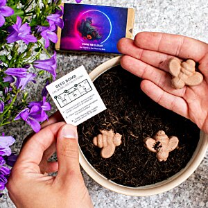 Additional Image 4 - a person holding a small piece of paper next to a potted plant