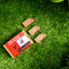 a red box with brown objects on grass