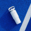 a white cup on a blue surface