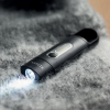 a black flashlight with a light coming out of it