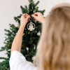 a person holding a christmas tree