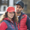 a man and woman wearing red and blue jackets