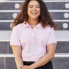 a woman smiling in a pink shirt