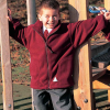 a boy standing in a park