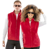 a man and woman wearing red vests