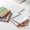 a notebooks and a pencil on a desk