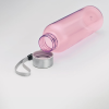 a pink plastic bottle with a silver measuring tape