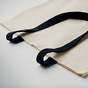 Additional Image 1 - a black strap on a white bag