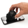 a hand holding a black object on a cell phone