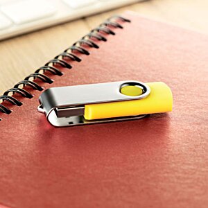 Additional Image 6 - a yellow and silver usb flash drive on a red notebook