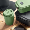 a green coffee cup and a black case