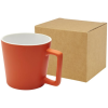 a red mug next to a brown box