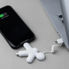 a cell phone charging with a white figure