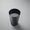 a black cup with a white liquid in it