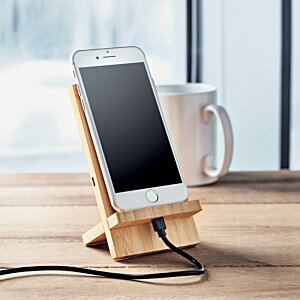 Additional Image 3 - a phone charging on a wood stand