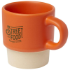 an orange and white coffee mug