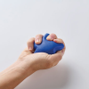 a hand holding a blue device