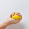 a hand holding a yellow ball