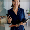 Additional Image 6 - a woman holding a phone and a folder