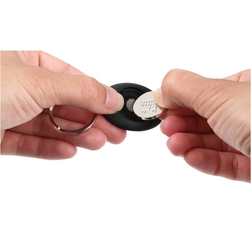 Additional Image 4 - a pair of hands holding a black and white coin