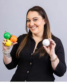 4imprint employee holding a variety of colours of stress balls