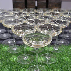 Row of champagne glasses lines up.