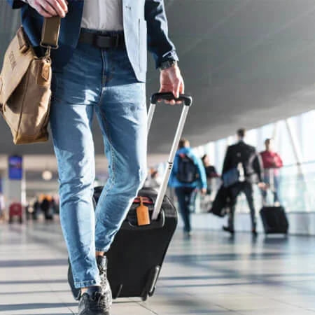 person pulling a piece of luggage.